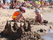 Answer sandcastle, sunbathing, tide